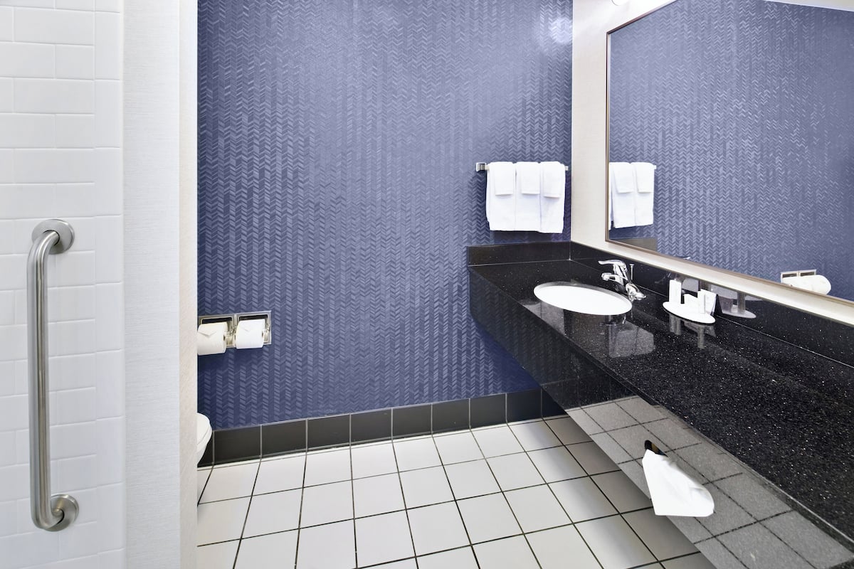 designer toiletries, hair dryer, towels, soap