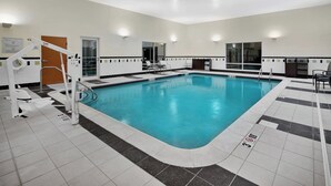 An indoor swimming pool with clear water, a lifeguard chair, and a changing room. - Fairfield Inn & Suites Marietta (Marietta)