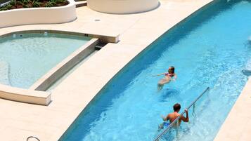 Enjoy a refreshing swim or soak in the hot tub, surrounded by a spacious deck area.