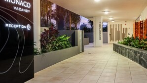 A modern hotel reception area with a sign indicating a vacancy.