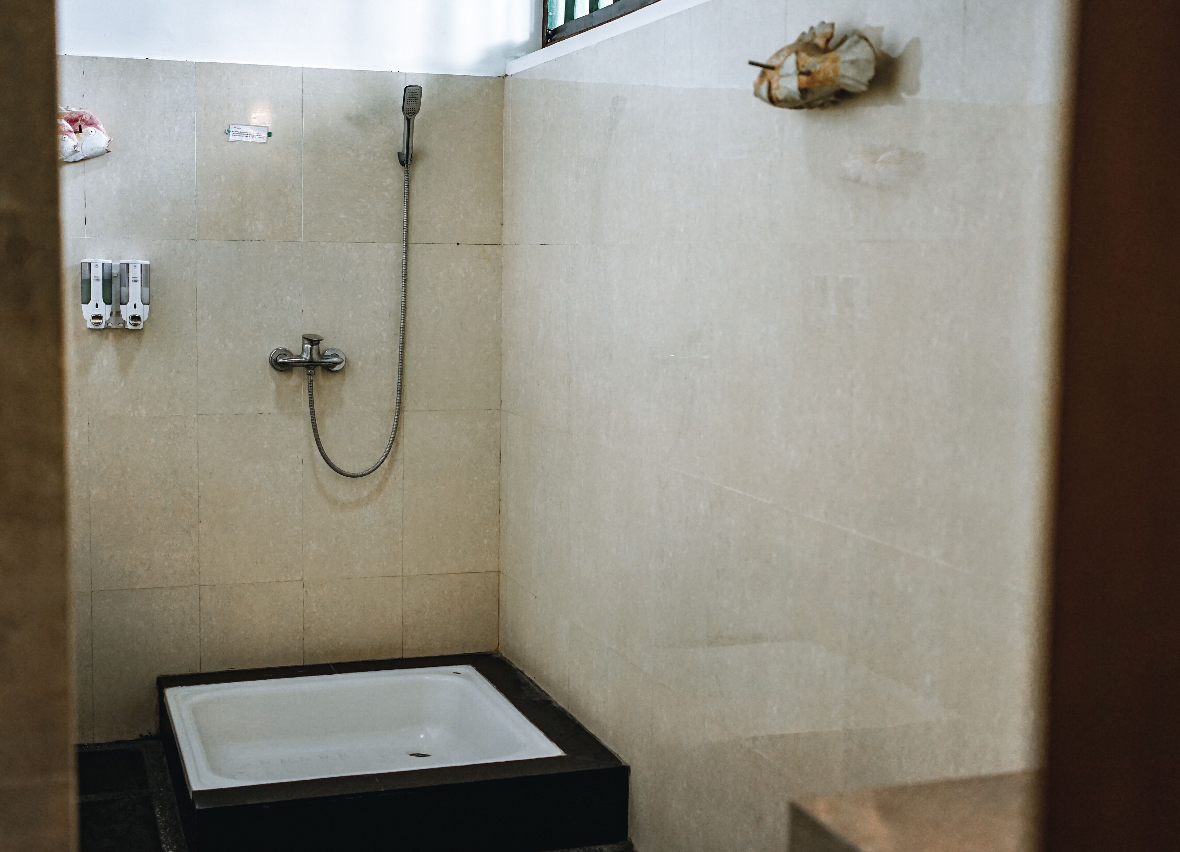 A bathroom with a bathtub, a shower, and a towel rack.