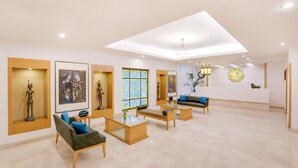 A spacious lobby with modern furniture, artwork on the walls, and a skylight. - Lemon Tree Hotel, Chandigarh (Chandigarh)