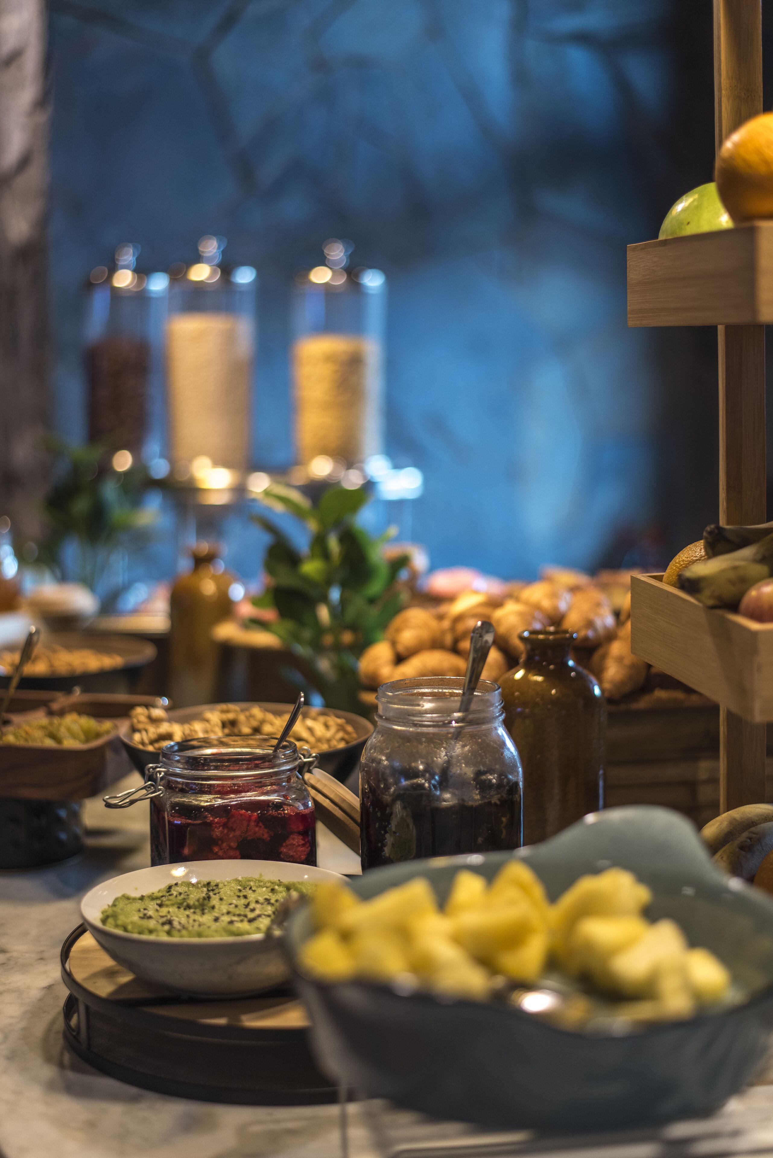 A buffet table with various food items and condiments.