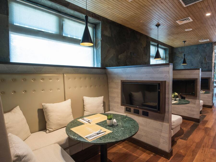A modern interior with a seating area, a fireplace, and a television.