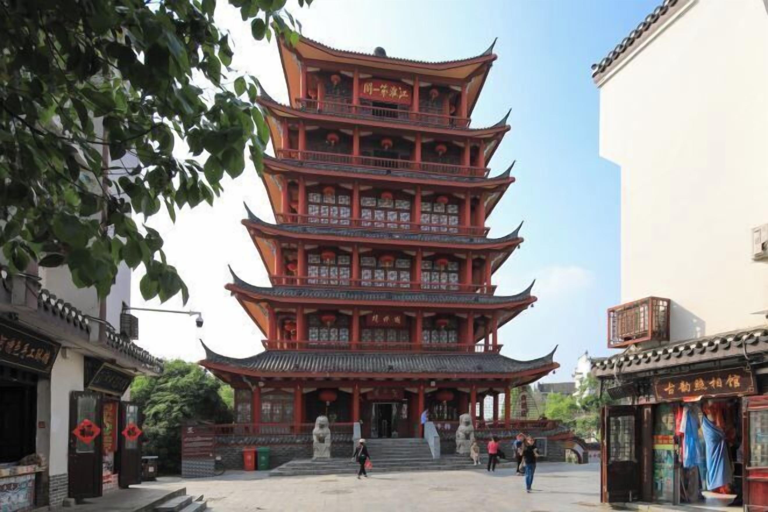 A traditional multi-tiered pagoda with a symmetrical design, surrounded by a courtyard with steps leading up to it.
