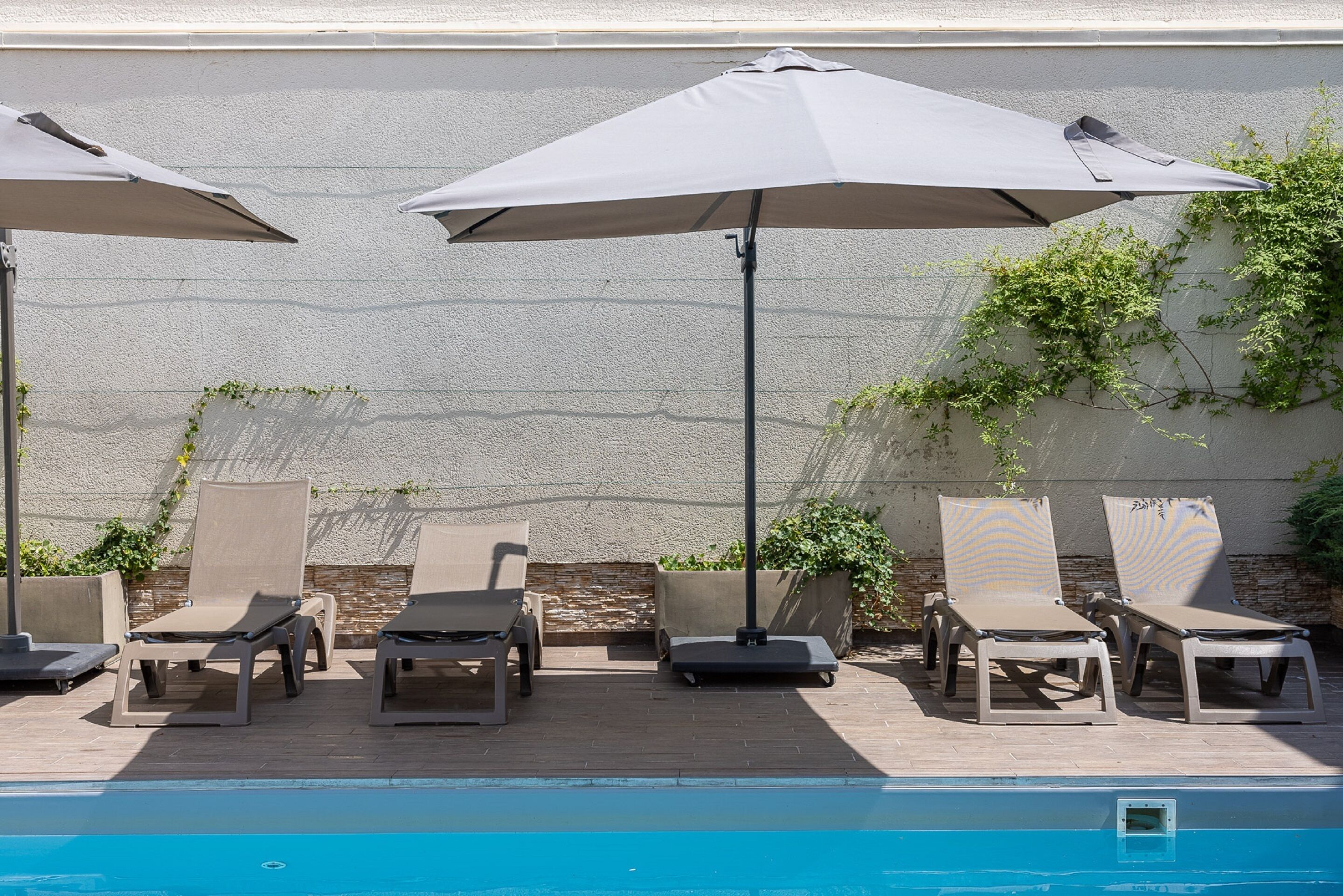 seasonal outdoor pool, open 9 am to 9 pm, pool umbrellas, pool loungers