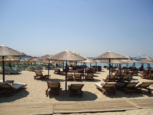 On the beach, sun-loungers, beach umbrellas