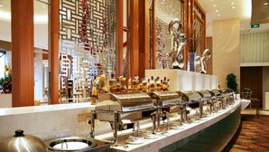 A buffet setup with multiple self-service stations, a decorative wall, and a patterned floor. - Glarun Jinling Hotel Nanjing (Nanjing)