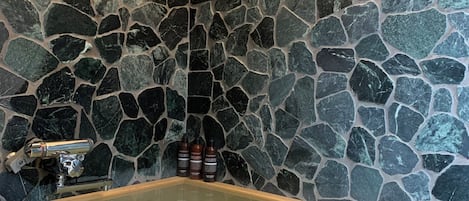 A stone wall with a bathtub.