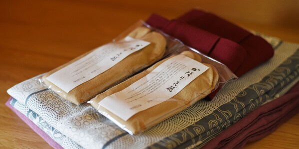 Two packages with labels on a patterned fabric surface.