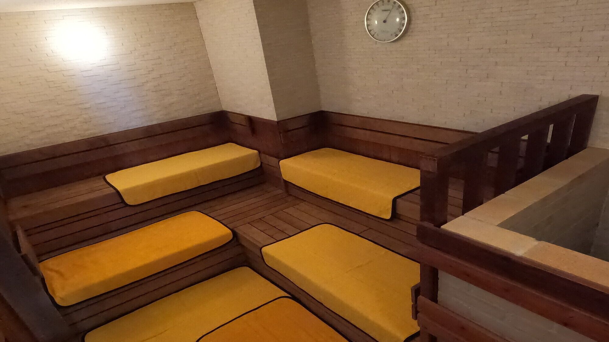 A room with wooden benches and a clock on the wall.