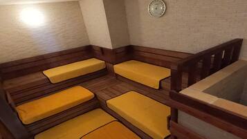 A room with wooden benches and a clock on the wall.