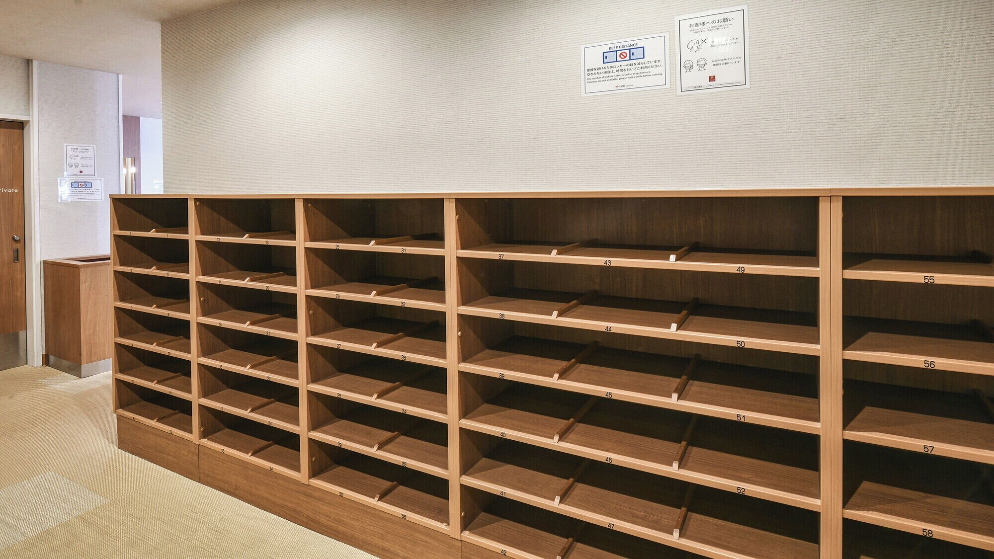 A storage area with multiple wooden shelves, each labeled with a number.