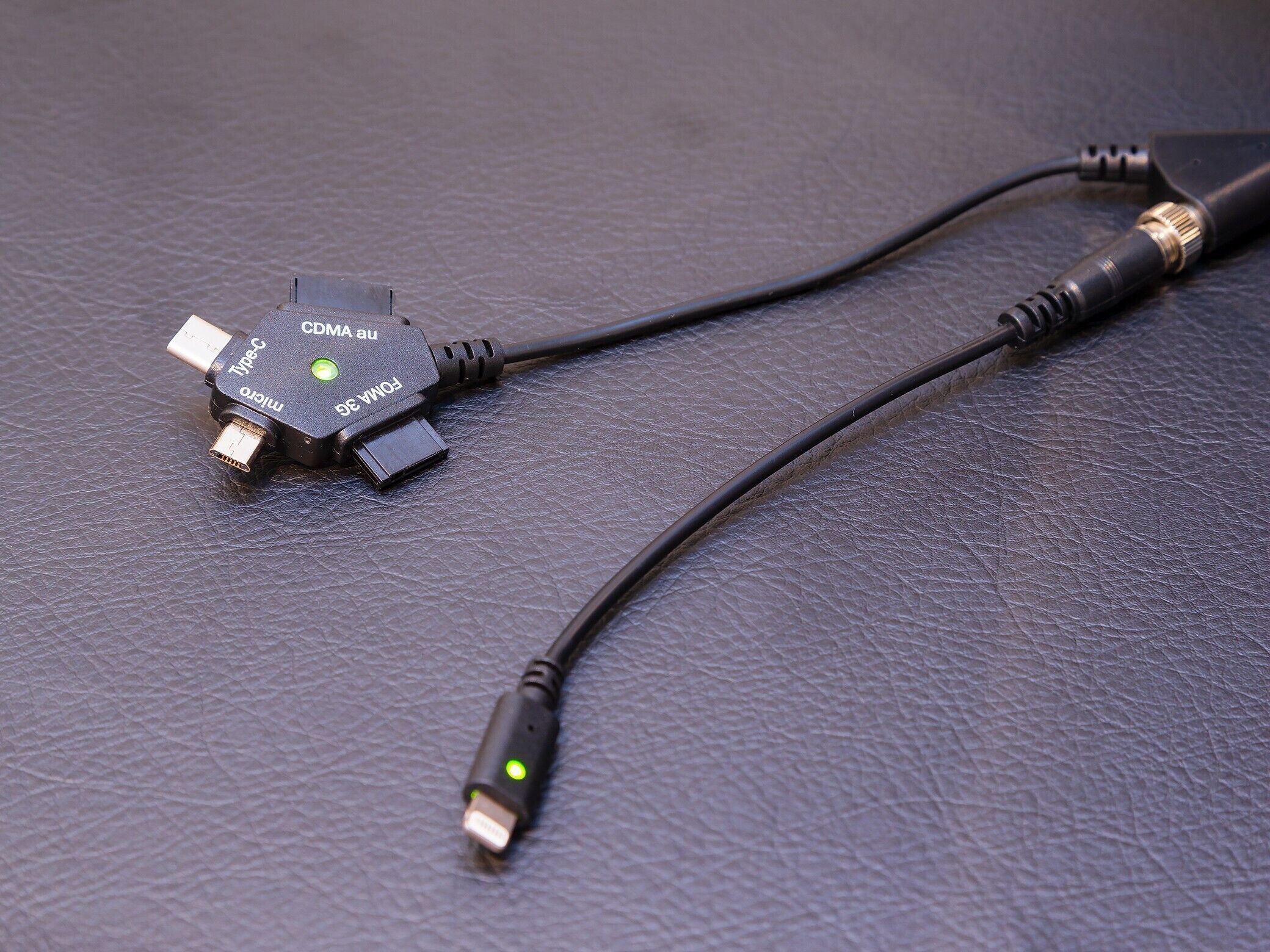A black cable with a USB connector and a power adapter.