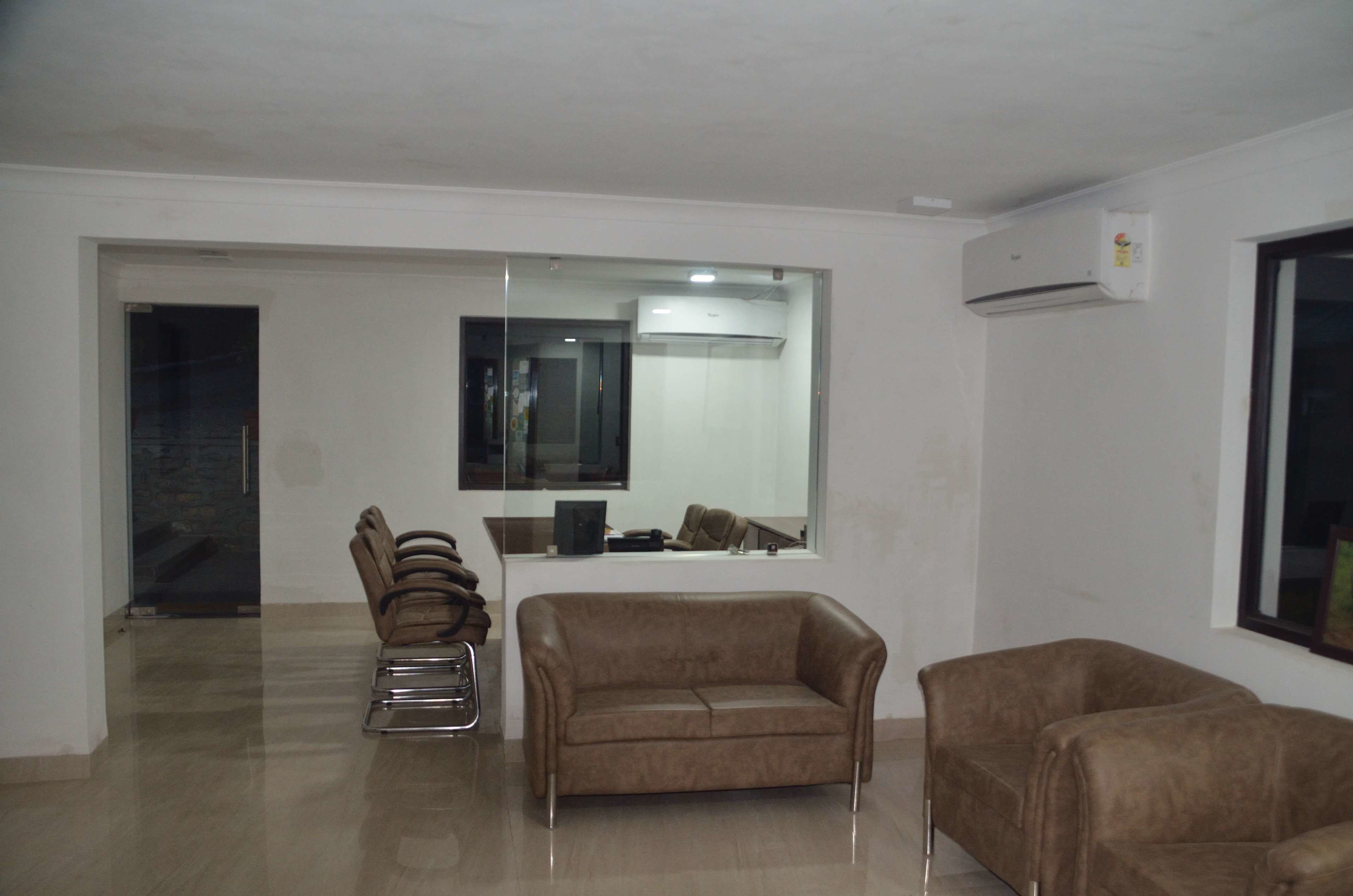 A modern living room with a sofa, a chair, and a small table.