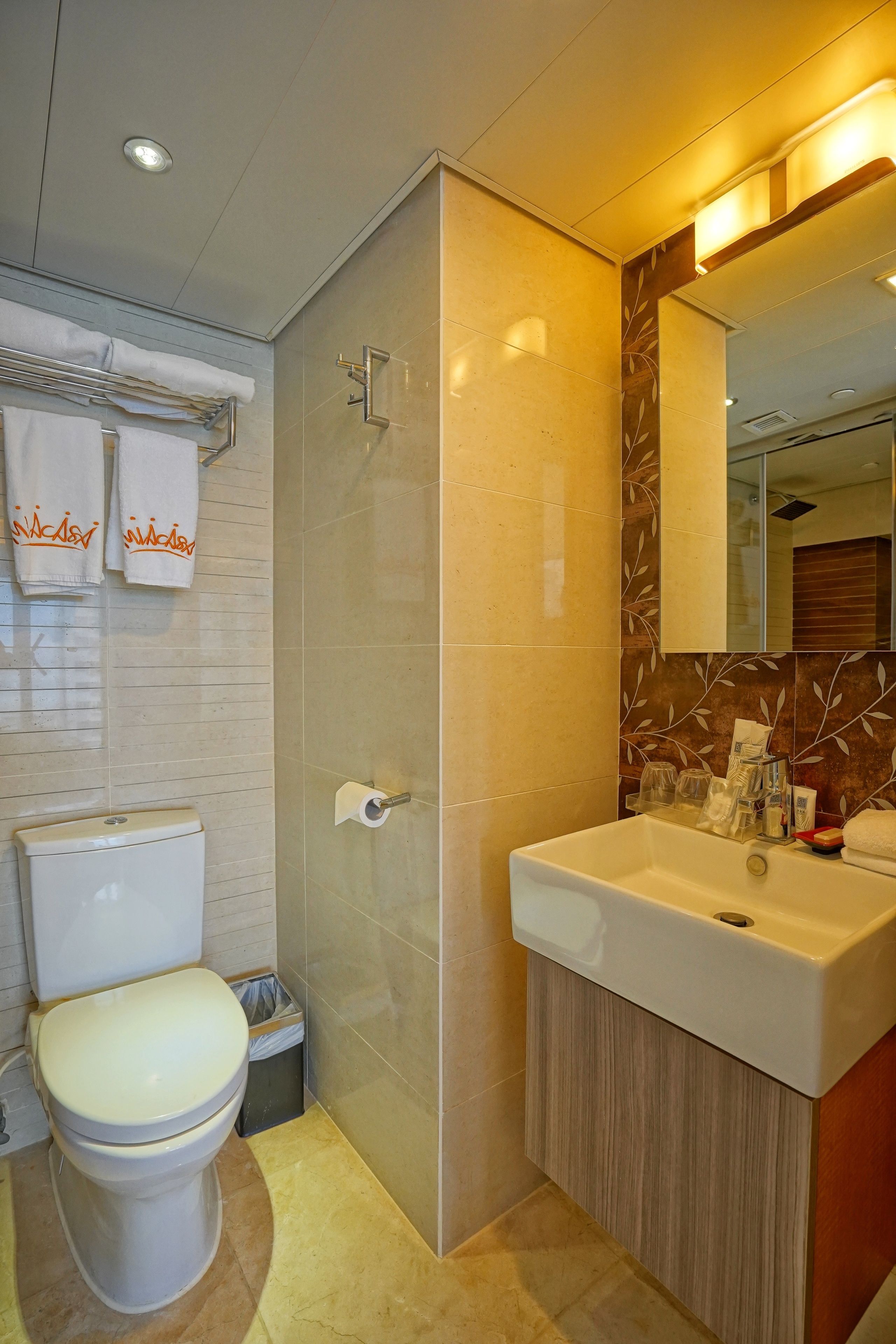 A modern bathroom with a toilet, sink, and shower.