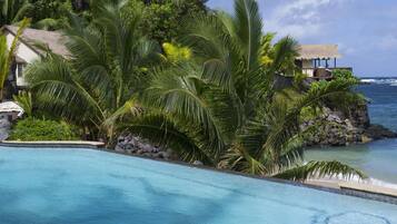 Een buitenzwembad, parasols voor strand/zwembad