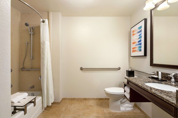 A modern bathroom with a shower, toilet, and sink.