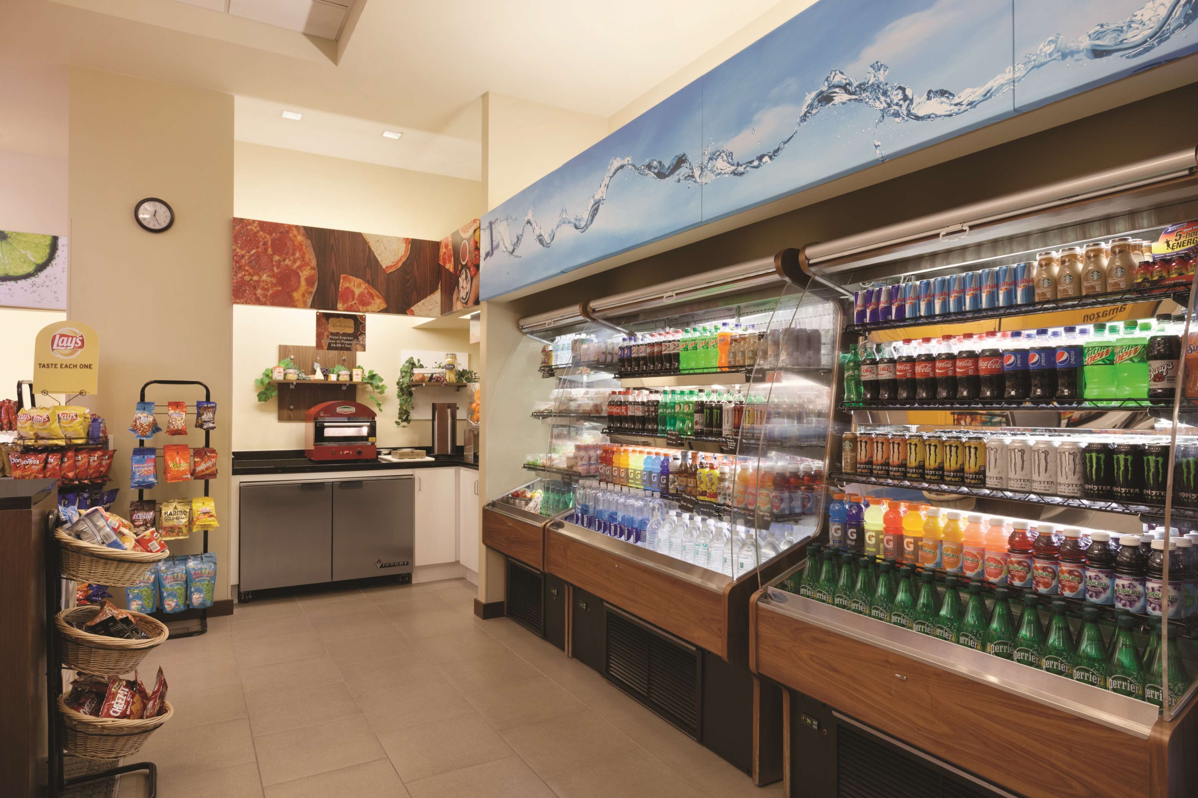 A self-service beverage station with various drinks and snacks.