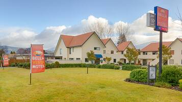 Experience the charm of Bella Vista Motel, surrounded by manicured lawns and scenic mountains.