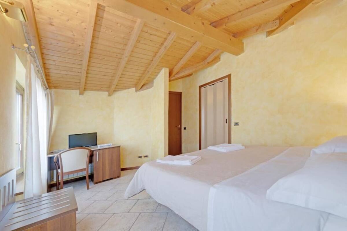 Een slaapkamer met twee bedden, een bureau en een stoel.