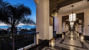 A grand hotel lobby with a reflective floor, ornate chandeliers, and a view of the ocean. - Hotel Riu Palace Tikida Agadir - All Inclusive (Agadir)