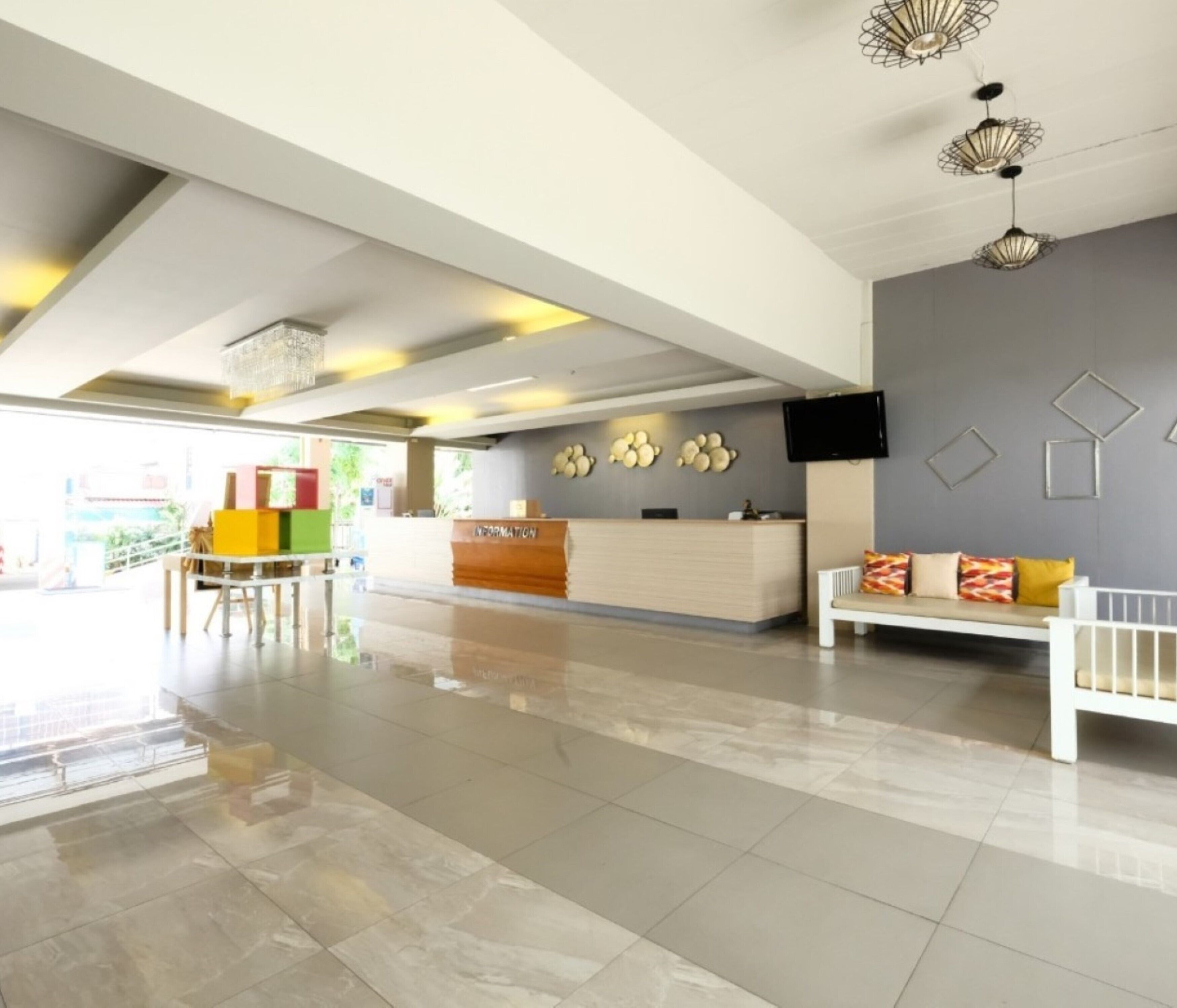 A modern reception area with a reception desk, seating area, and decorative wall art.