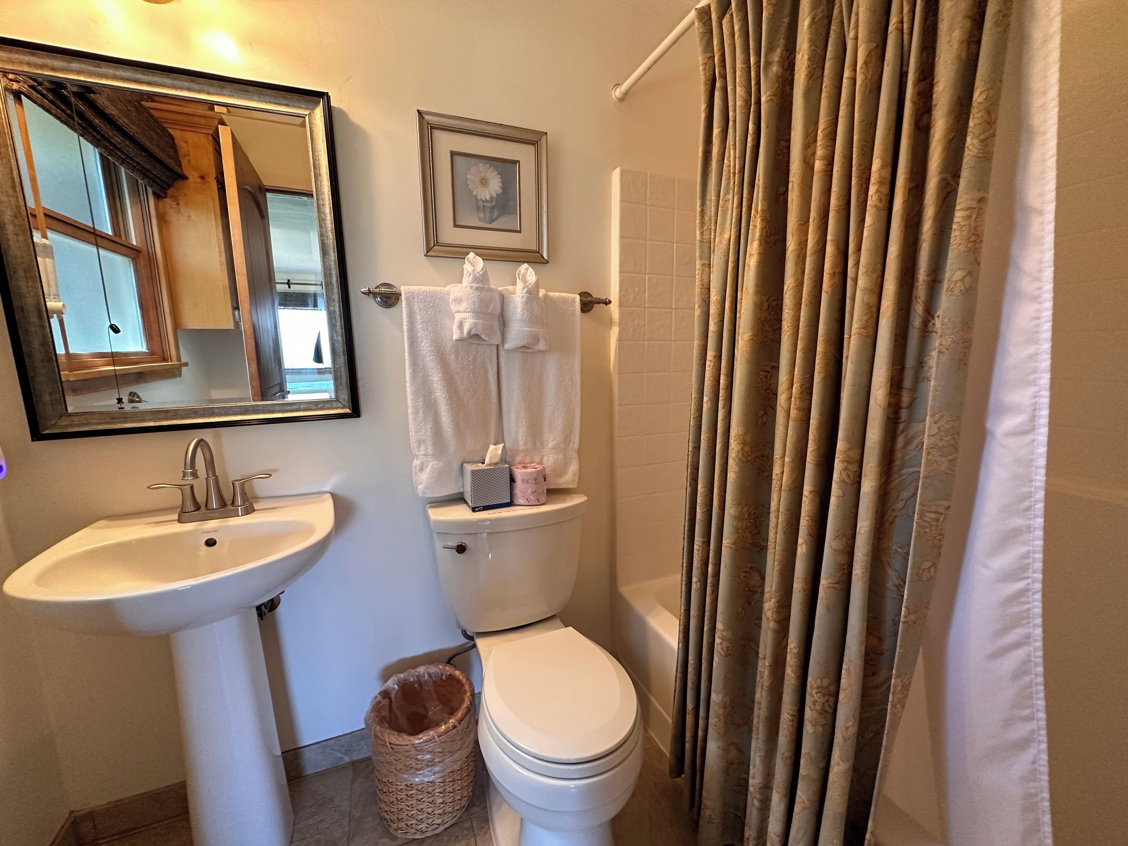 Ein Badezimmer mit Waschbecken, Toilette und Duschvorhang.
