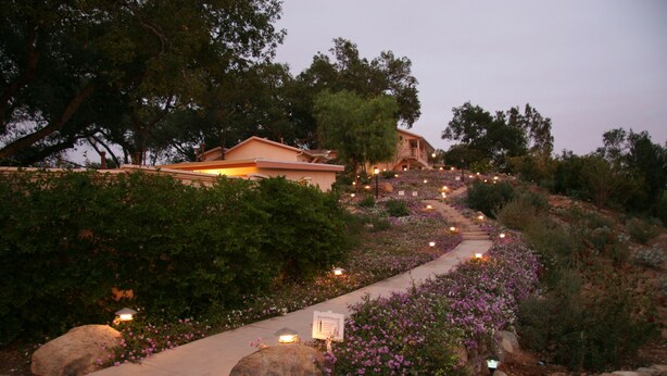 A pathway leading to a hillside house with a garden. - Ojai Retreat & Inn (Ojai)