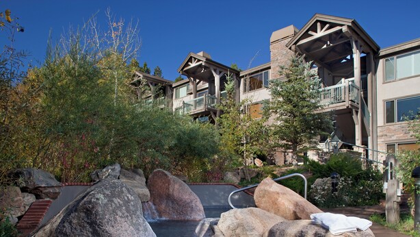 A pool with large rocks and a towel on one of the rocks. - Terracehouse - CoralTree Residence Collection (Snowmass Village)