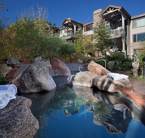 A pool with large rocks and a towel on one of the rocks. - Terracehouse - CoralTree Residence Collection (Snowmass Village)