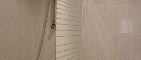 A bathroom with a shower, toilet, and sink.