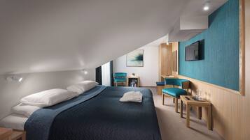 Una habitación de hotel moderna con cama, zona de estar y televisor.