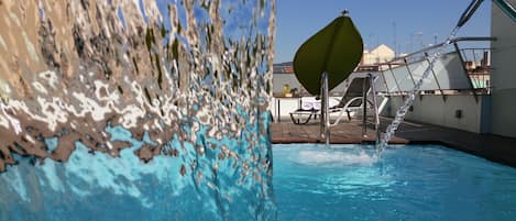 Seasonal outdoor pool, open 10:00 AM to 7:00 PM, pool loungers