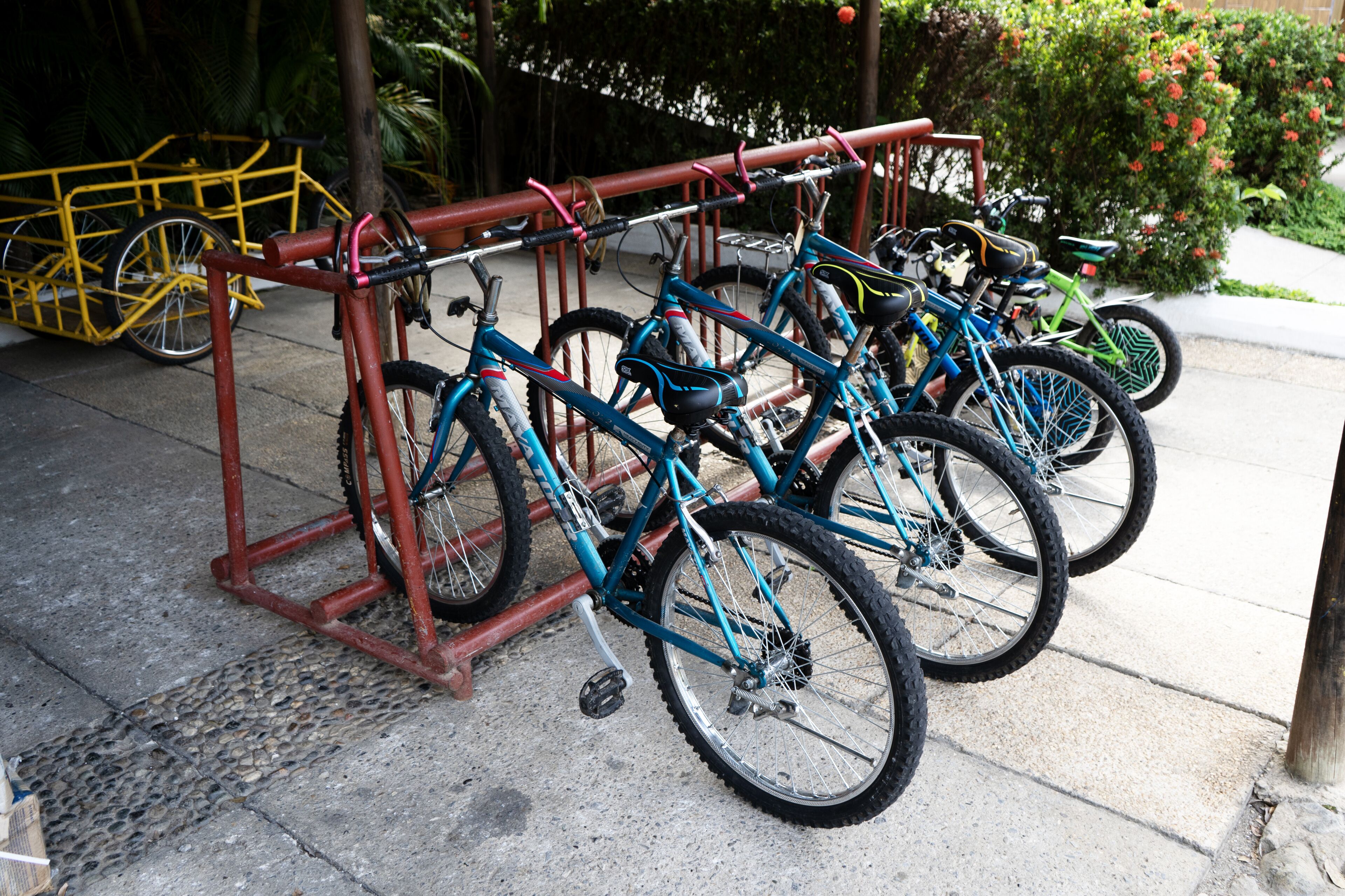 A bike rack with multiple bicycles parked.