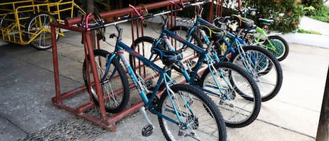 A bike rack with multiple bicycles parked.