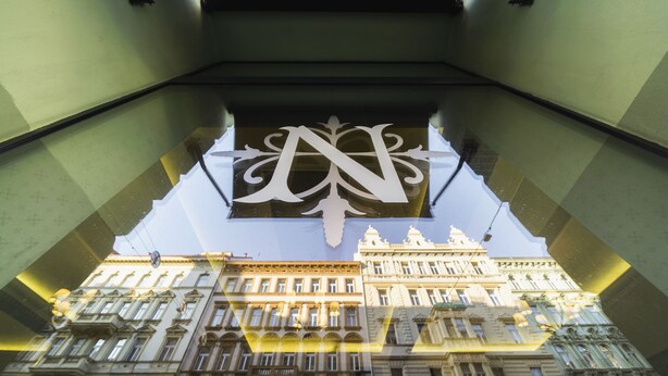 A building facade with ornate architectural details and a large, stylized letter 'N' above the entrance. - Hotel Noir (Prague)