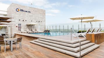 Outdoor pool, open 9:00 AM to 9:00 PM, pool umbrellas, pool loungers