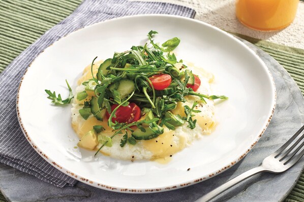 A white plate with a salad on top of a white base, possibly polenta, with a fork on the side. - Courtyard Philadelphia Coatesville/Exton (Coatesville)