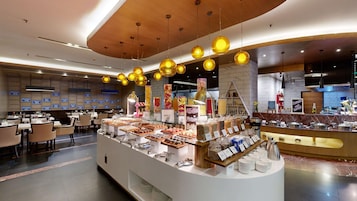 A buffet area with various food items and a coffee station.