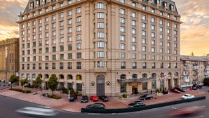 A large, multi-story hotel with a classic architectural style, featuring a prominent entrance and multiple windows.
