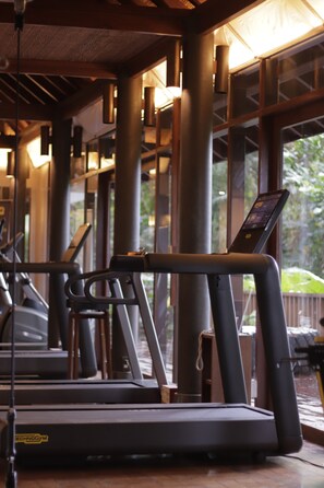 A gym with treadmills, exercise equipment, and large windows allowing natural light. - The Farm at San Benito, Autograph Collection (Lipa)