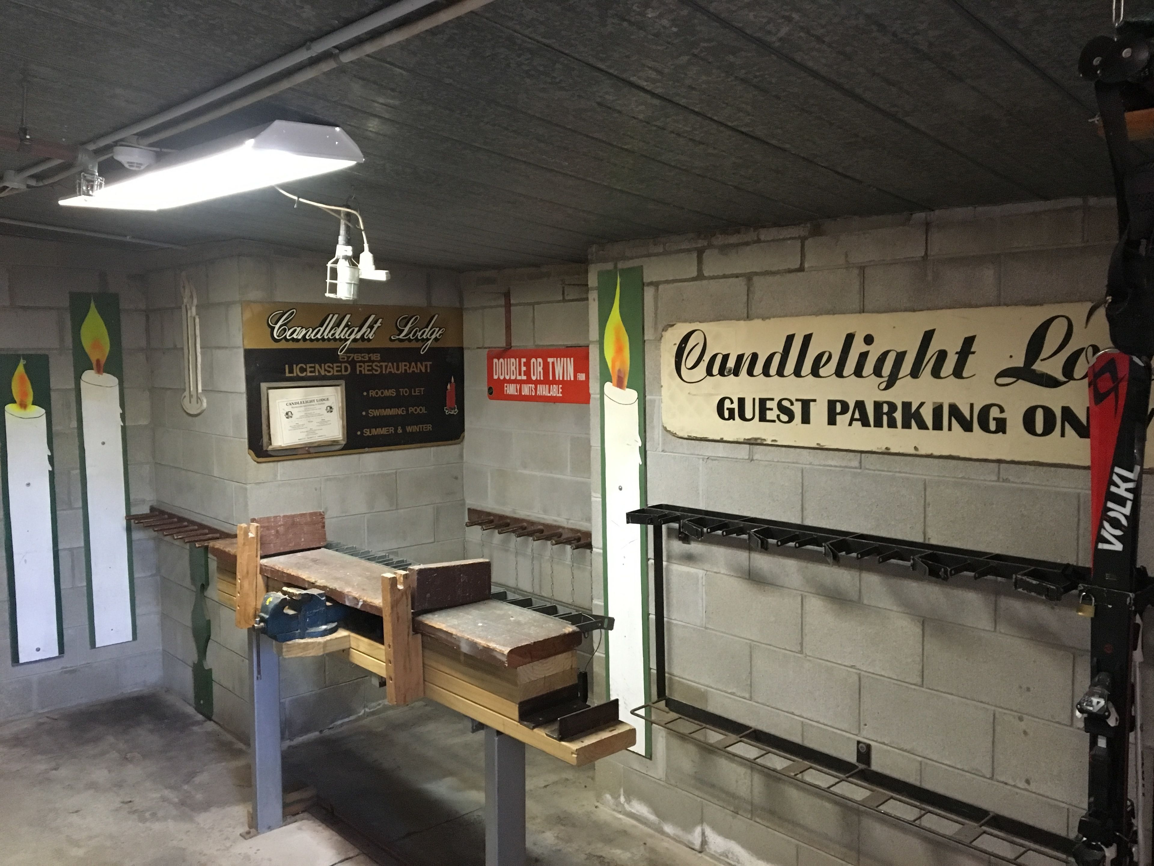 Ein Parkbereich für Gäste mit Schildern für Candlelight Lodge, ein Restaurant mit Betriebsgenehmigung, und einem Schild, das angibt, dass Familienzimmer mit Doppel- oder Einzelbetten verfügbar sind.
