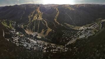 A mountainous landscape with a valley containing a small town with houses and roads.