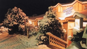 A snow-covered lodge with a sign reading "Candlelight Lodge."