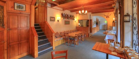 Un interior de madera con una escalera, un comedor y una cocina.