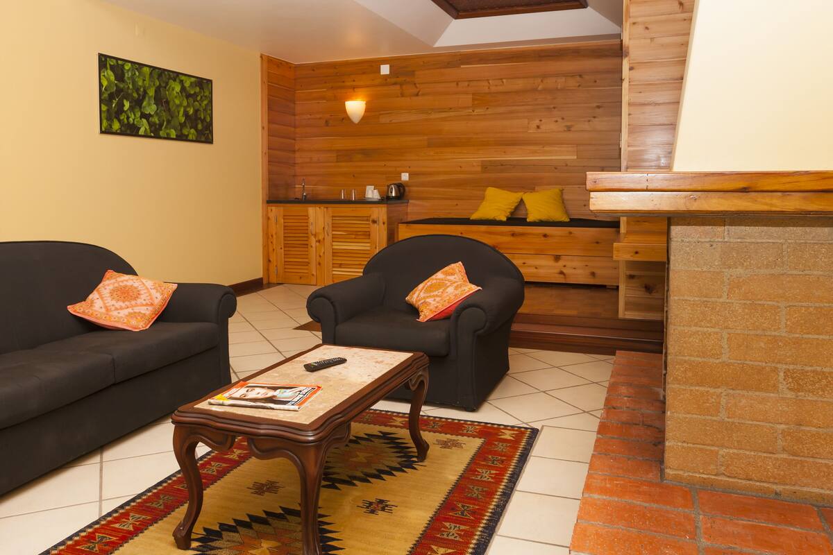 suite (3 guests) | living area | 24-inch lcd tv with cable channels, tv