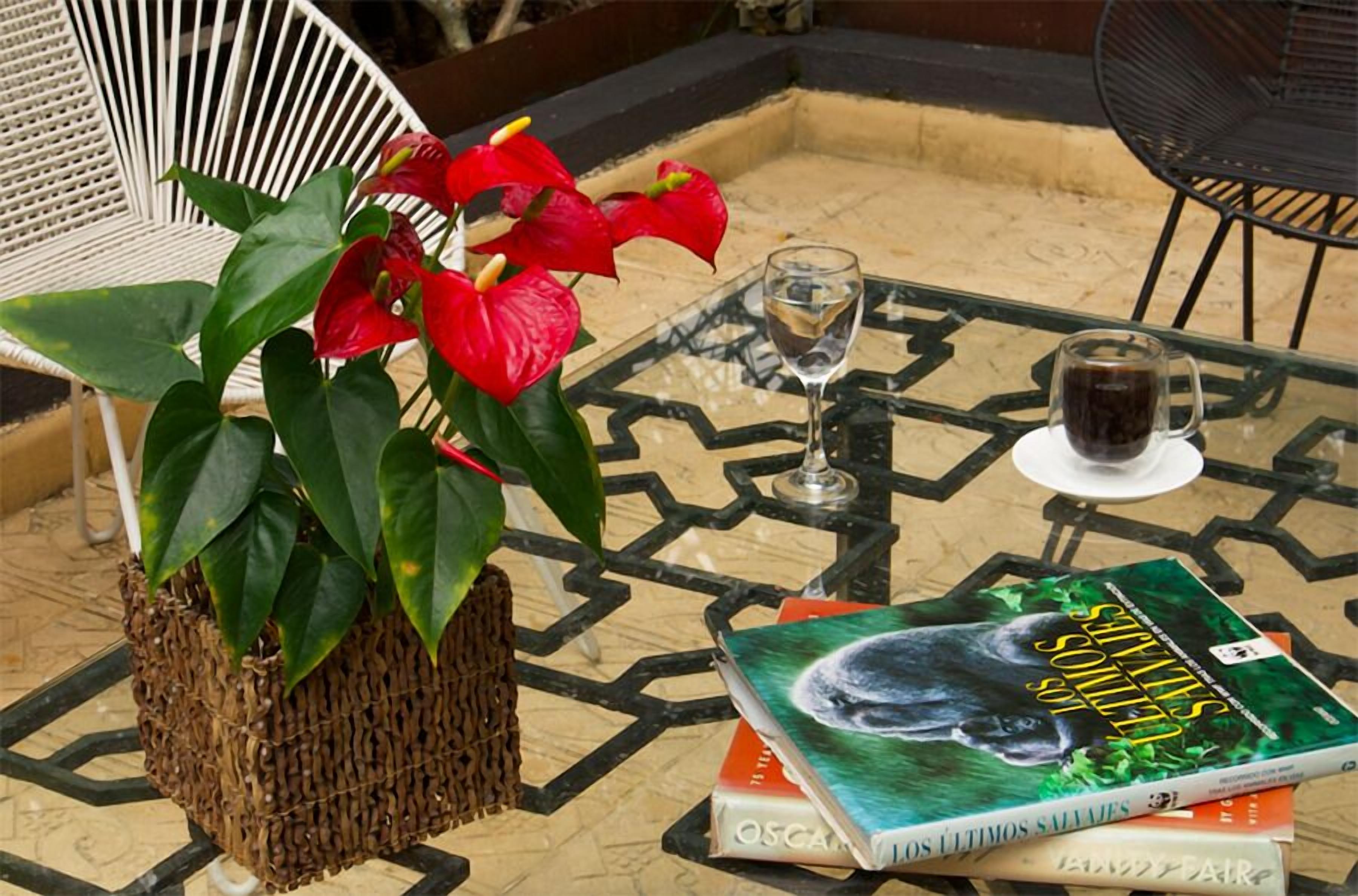 A table with a book, a glass of water, and a glass of coffee.