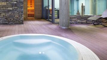 Relax by the serene oval pool, surrounded by a textured edge and a rustic stone wall.