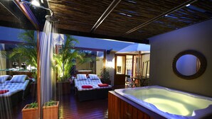 A spa area with a hot tub, lounge chairs, and a shower. - The Residence Boutique Hotel (Johannesburg)